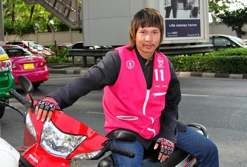 Challenges Faced by Motorcycle Taxi Drivers in Colorful Attire